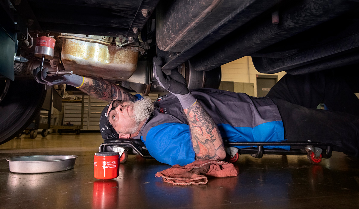 Photo of technician working under truck